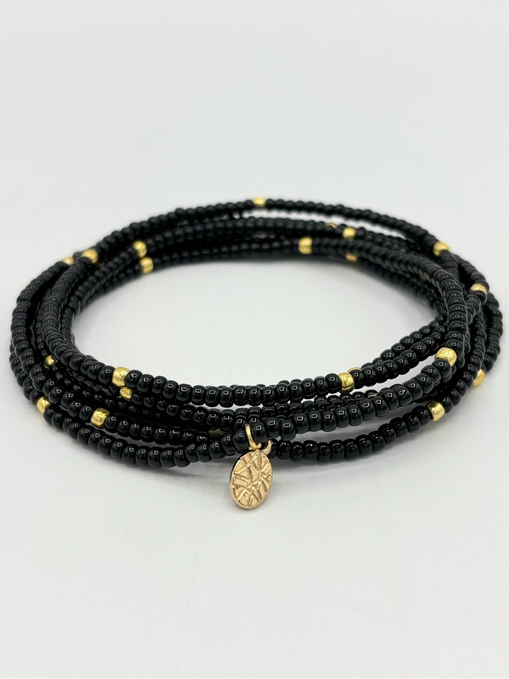 Hand Crafted Black and Gold Beaded Wrap Bracelet with Gold Charm